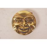 A brass vesta case in the form of moon faces, 2" diameter