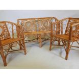 A 60s cane conservatory suite consisting of two chairs and a settee, 28½" high