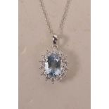 An 18ct white gold pendant necklace set with an aquamarine encircled by diamonds, approximately 2.