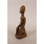 An African carved wood tribal figure, 7½" high