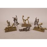 A collection of seven African Benin brass and bronze figures in erotic poses, largest 4" high