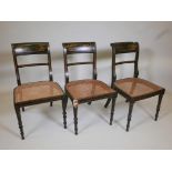 Three Regency japanned and parcel gilt side chairs with cane seats, raised on ring turned supports