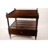 A mahogany canterbury with single base drawer raised on brass castors, 18" x 19" x 15"