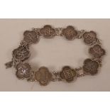A Chinese silver bracelet made from ten linked panels, each bearing different character marks, 12.