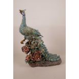 A large Chinese polychrome pottery phoenix amongst flowers, impressed marks verso, 16½" high, A/F