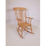 A beech framed Windsor rocking chair of traditional style