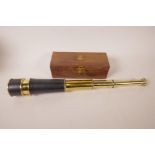 A leather cased three draw brass telescope in hardwood box, 18" long extended