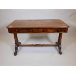 A Holland and Sons Victorian walnut two drawer side table, raised on column ends with carved cabriol