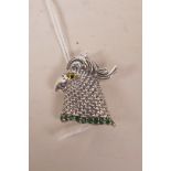 A sterling silver brooch in the form of a cockerel's head, set with an emerald band, 1½"
