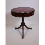 A late C19th mahogany drum table, with revolving top inset with blind tooled leather, fitted with
