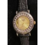 A ladies' dress watch with bejewelled bezel and leather strap