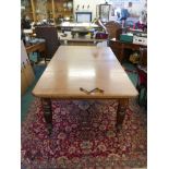 An early Victorian mahogany wind out dining table with patent winder by Joseph Fitter and two