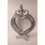 A heart shaped garden candle lantern, with pierced metal body and double sided glass doors, 20" high