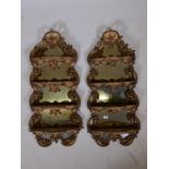 A pair of Victorian giltwood and composition mirror backed hanging wall shelves, 40" high