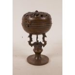 A Chinese bronze ball censer with pierced dragon decoration to cover, 6" high