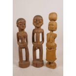 A collection of three Oceanic carved wood fetish figures, largest 11" high