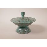 A Chinese turquoise glazed pottery censer with pierced cover and lotus flower decoration,