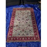 An ivory ground Kashmir carpet with all over floral pattern bespoke red border, 120" x 78"