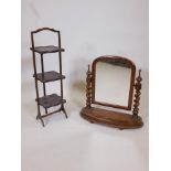 A Victorian mahogany three tier folding cake stand, together with a swing toilet mirror on