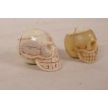 Two sectional bone beads carved in the form of skulls, largest 1½"