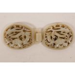 A Chinese carved and pierced white jade belt buckle with dragon decoration, 5" x 2"