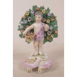 A C19th hard paste porcelain bricolage figurine of a child gathering flowers, bears gold anchor