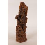 A Chinese boxwood carving of Lohan in a rocky landscape, 9" high