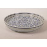 A Chinese blue and white porcelain shallow dish with scrolling lotus flower decoration, 7½" diameter