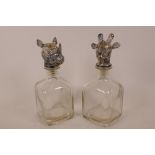 A pair of moulded glass decanters, the stoppers cast as animal heads, 10" high