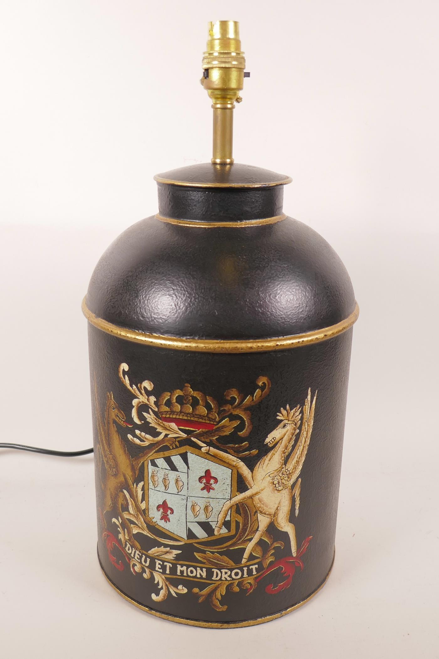 A metal table lamp in the form of a toleware churn and cover painted with a coat of arms, 18" high