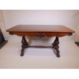 An early C19th mahogany library table with a single drawer, banded top, carved decoration, raised on