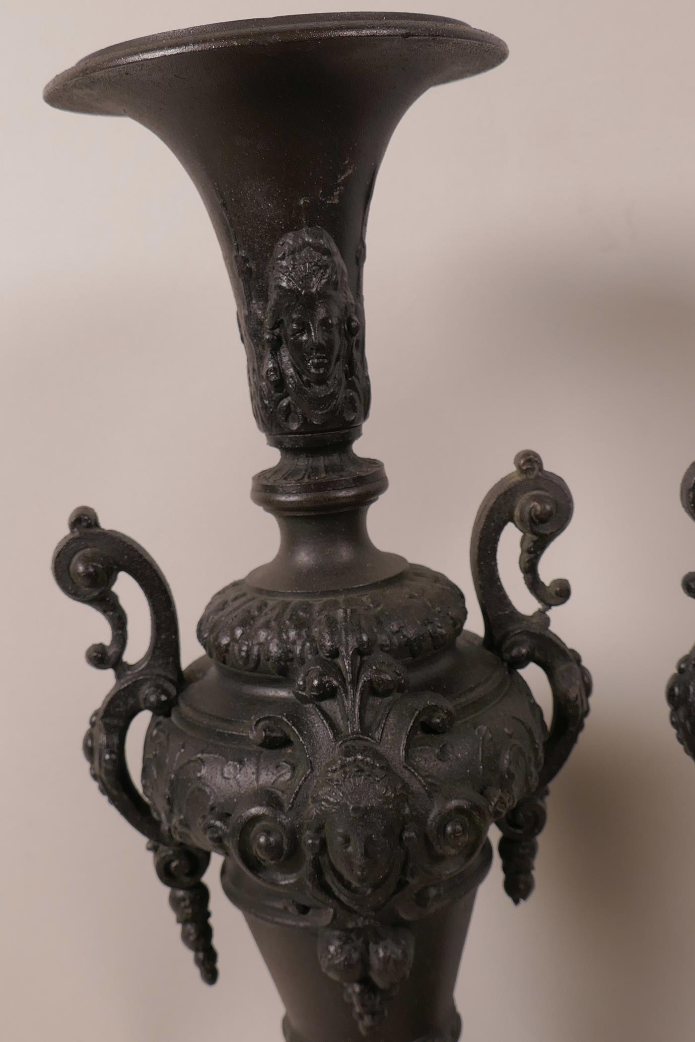 A pair of Victorian spelter side urns decorated with masks and swags, mounted on turned wooden - Image 2 of 2