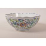 A Chinese doucai porcelain bowl with a lobed rim and scrolling lotus flower decoration, 6