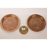 A pair of copper wall plaques inlaid with Islamic calligraphy, 9" diameter, and a small brass