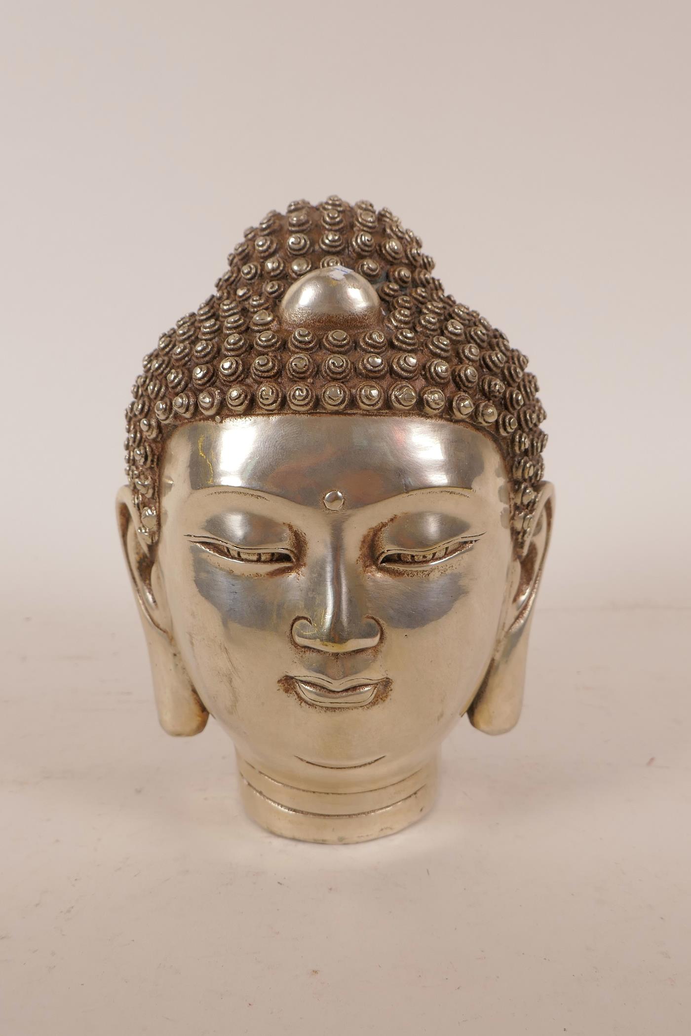 A Chinese filled and silvered metal Buddha head, impressed 4 character mark to base, 6½" high