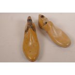 Two mid-Victorian hinged wooden shoe lasts; one lady's right foot with pointed toe, and one child'