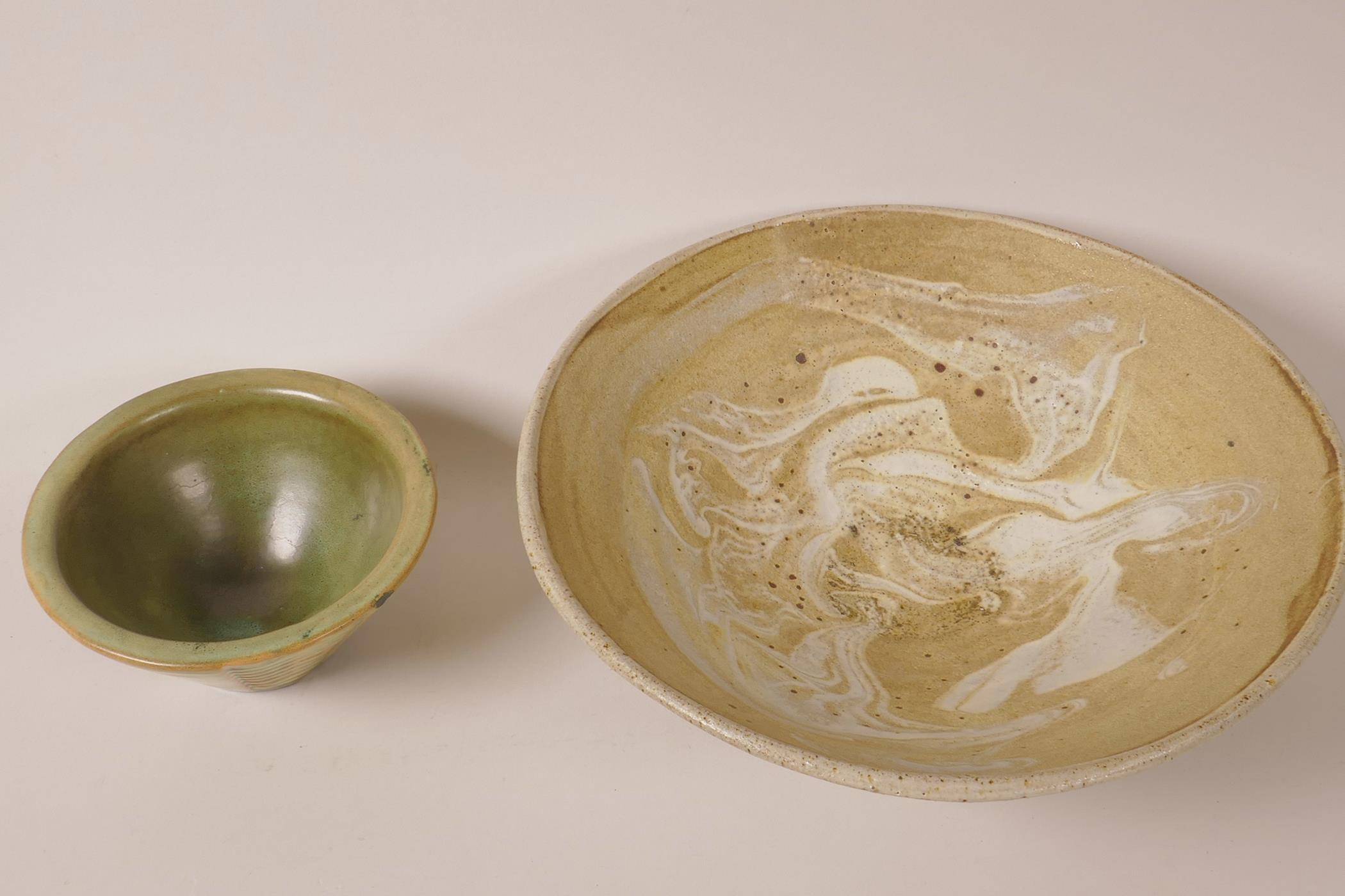 A drip glazed studio pottery bowl, 10½" diameter, signed, together with a smaller ceramic bowl