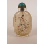 A Chinese reverse decorated glass snuff bottle depicting an immortal riding an elephant, character