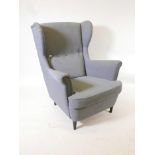 An Ikea 'Strandmon' wing back armchair, covered in 'Nordvalla dark grey', 41" high