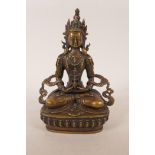 A Sino-Tibetan bronzed metal figure of Buddha seated on a lotus throne, 8½" high