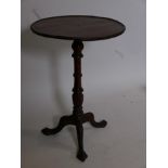 A mahogany dish top wine table on carved pedestal base and three ball and claw feet, 26" high, 18"