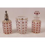 A Baccarat three piece glass dressing table set of perfume decanter, atomiser and tumbler, red and