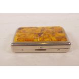 A plated cigarette box with amber shards set to the cover, 3½" x 2"