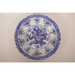 A Chinese blue and white porcelain charger with a lobed rim and dragon decoration, 14" diameter