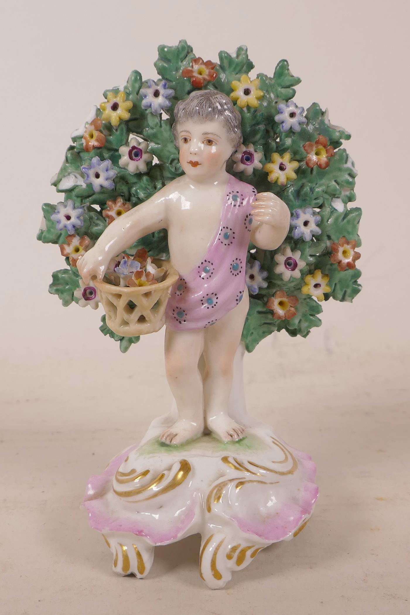 A C19th hard paste porcelain bricolage figurine of a child gathering flowers, bears gold anchor