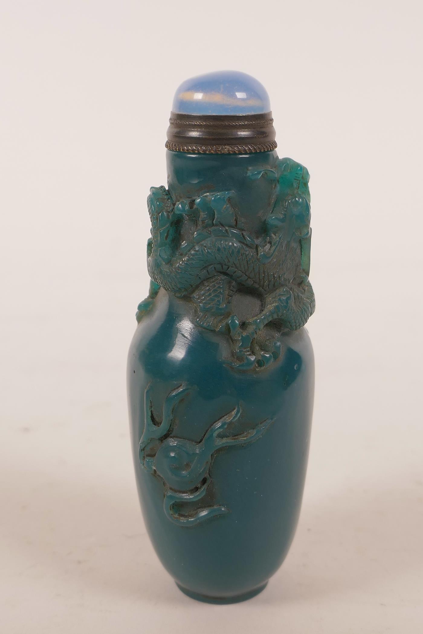 A Chinese blue glass snuff bottle with carved decoration of a dragon chasing the flaming pearl, 4" - Image 4 of 4