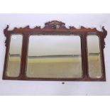 A Georgian style mahogany and parcel gilt triple overmantel mirror, with shaped top and carved ho ho