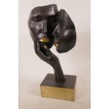 A Modernistic bronze of two masks and a hand, 17" high, signed