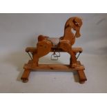 A child's pine rocking horse, 35" long, 34" high