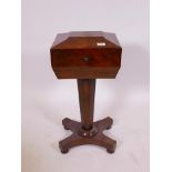 A Regency mahogany teapoy, raised on a tapering column and platform support with carved detail,